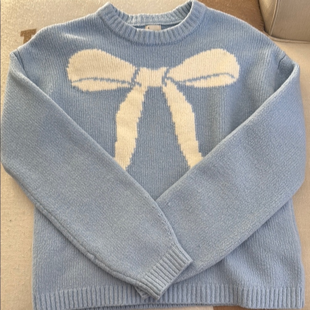 A new day light blue knit sweater with graphics
